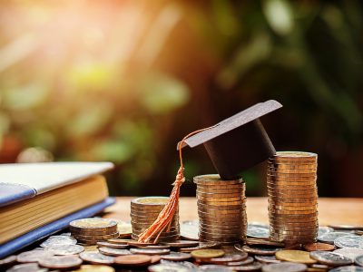 hat graduation model on money coins saving for concept investment education and scholarships